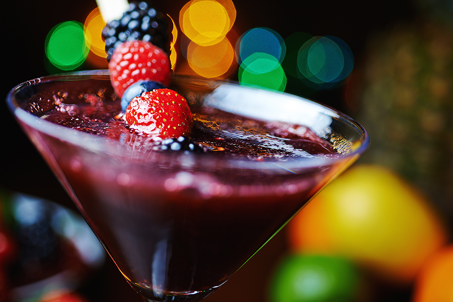 close up glass of tropical cocktail with berries or lemonade. enjoy holiday without alcohol