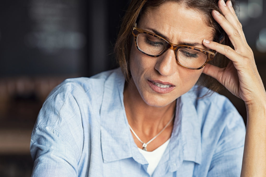 Stressed woman wearing eyeglasses how clutter affects your life
